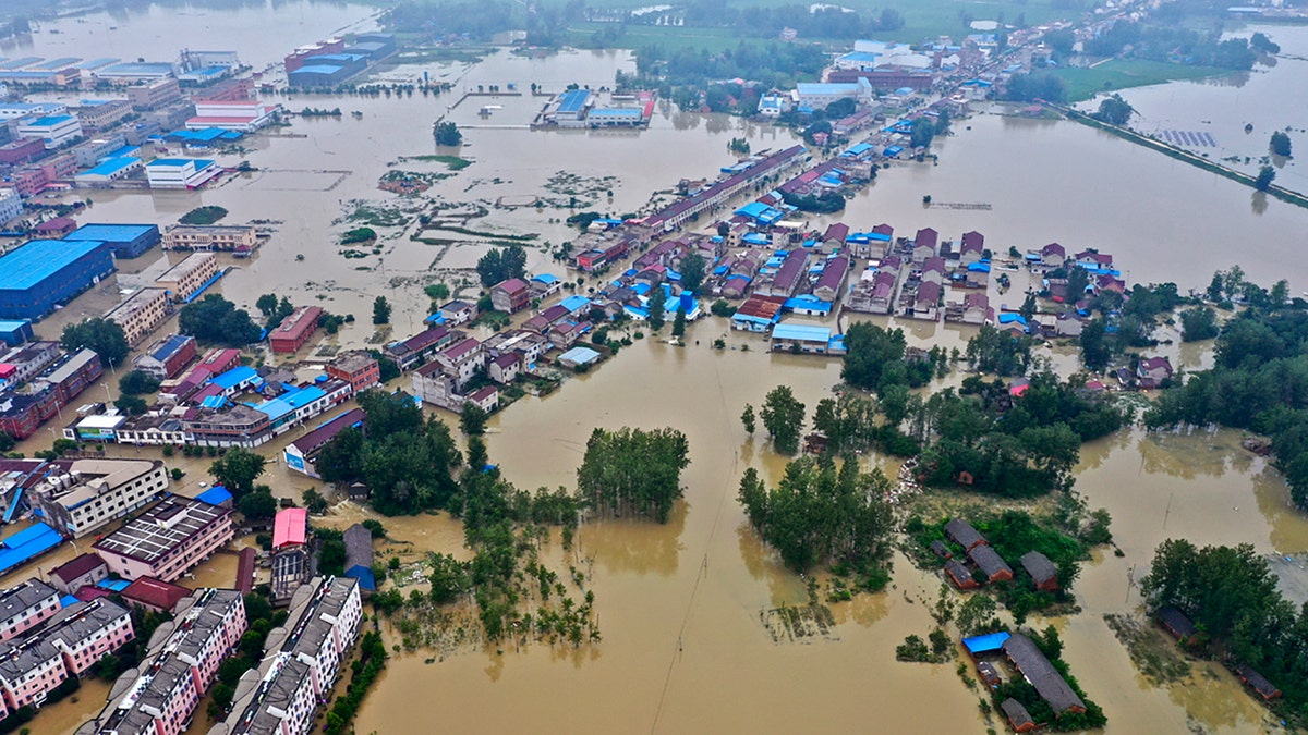 This July 20, 2020, aerial file photo released by Xinhua News Agency shows the extent of flooding in Guzhen Town of Lu'an City in eastern China's Anhui Province.