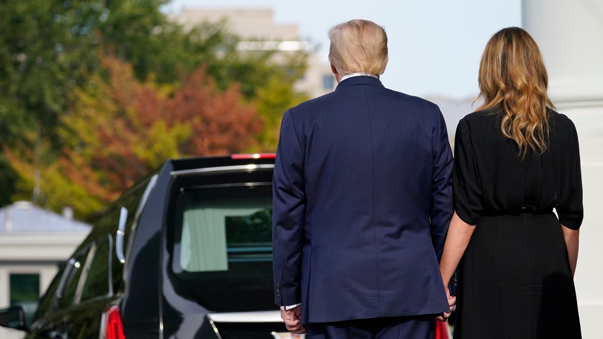 President Donald Trump and first lady Melania Trump hold hands after the casket of Robert Trump was loaded into the hearse after a memorial service for the president's younger brother at the White House on Friday, Aug 21, 2020, in Washington. (AP Photo/Evan Vucci)
