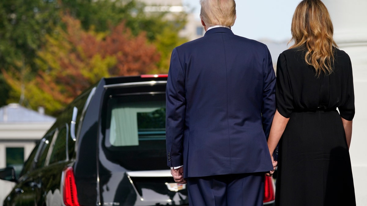 President Donald Trump and first lady Melania Trump hold hands after the casket of Robert Trump was loaded into the hearse after a memorial service for the president's younger brother at the White House on Friday, Aug 21, 2020, in Washington. (AP Photo/Evan Vucci)