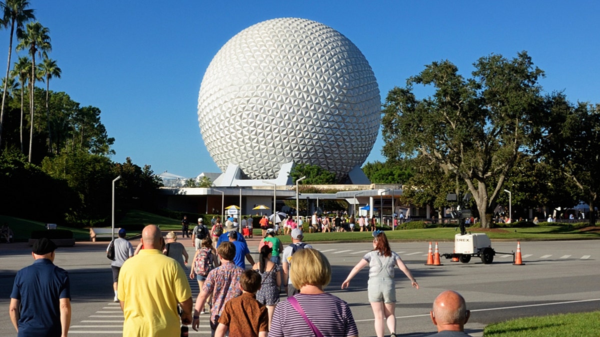 Visitors walk into Walt Disney World Resort's Epcot theme park