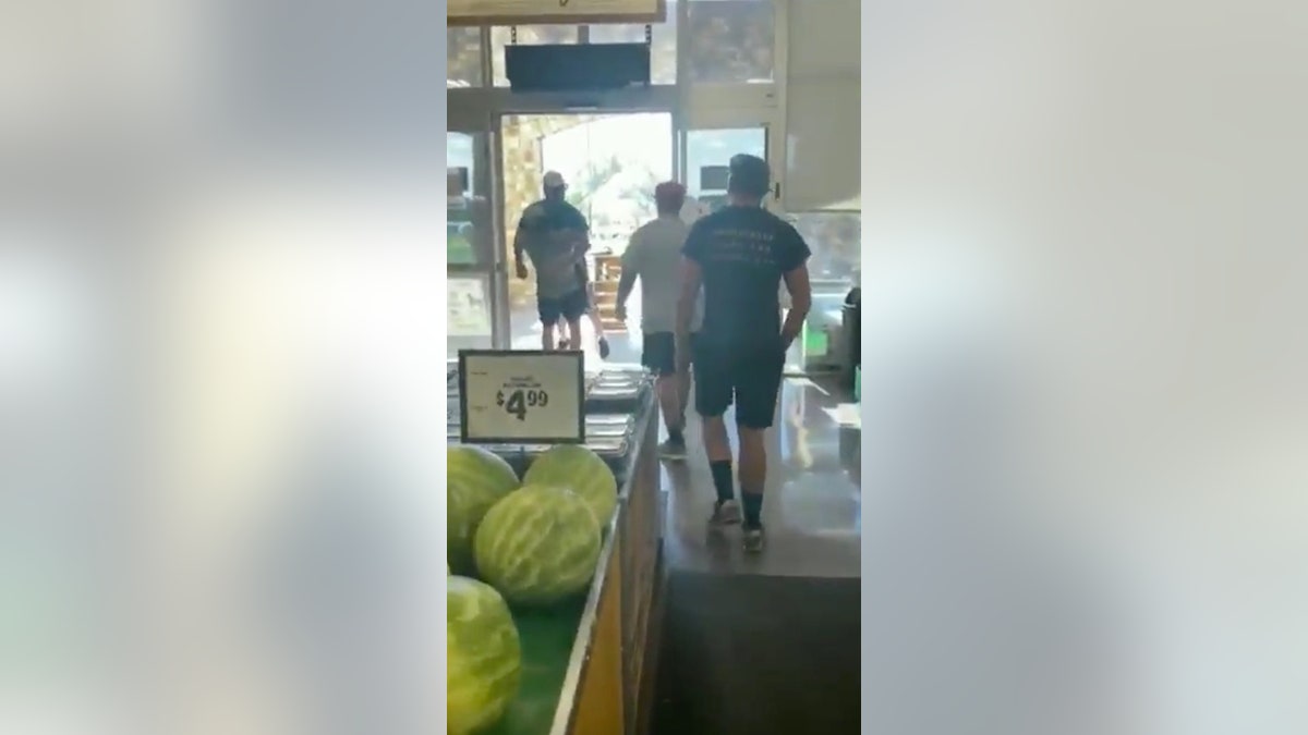 At one point, a young man identified as the disgruntled customer's son hoisted him up and carried him outside the store.