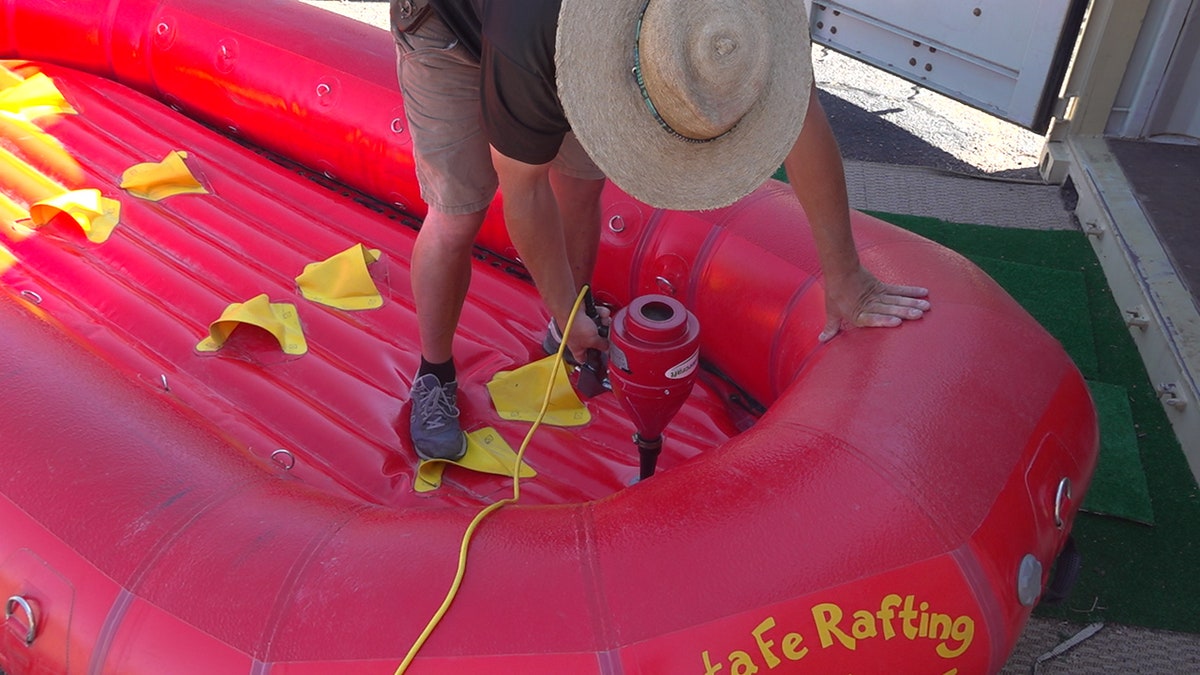 Santa Fe Rafting Co. owner Jared McClure prepares rafts for the next trip. They clean all equipment and set it aside for 24-48 hours before the next use.