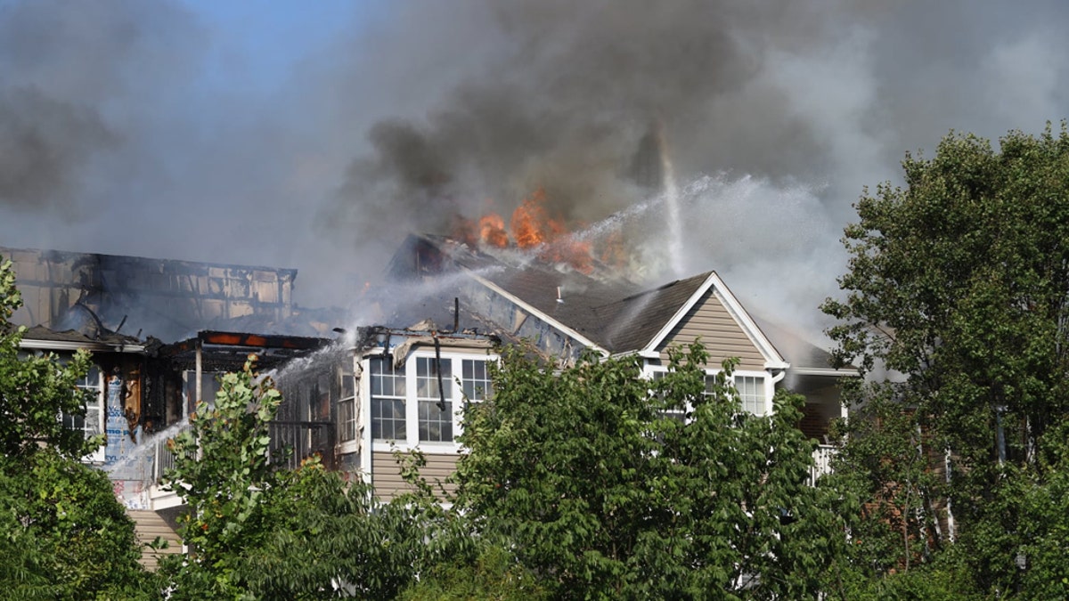 The three-story, garden-style complex was up in flames when first responders arrived at the scene, with heavy smoke and fire billowing from the rear from the structure.