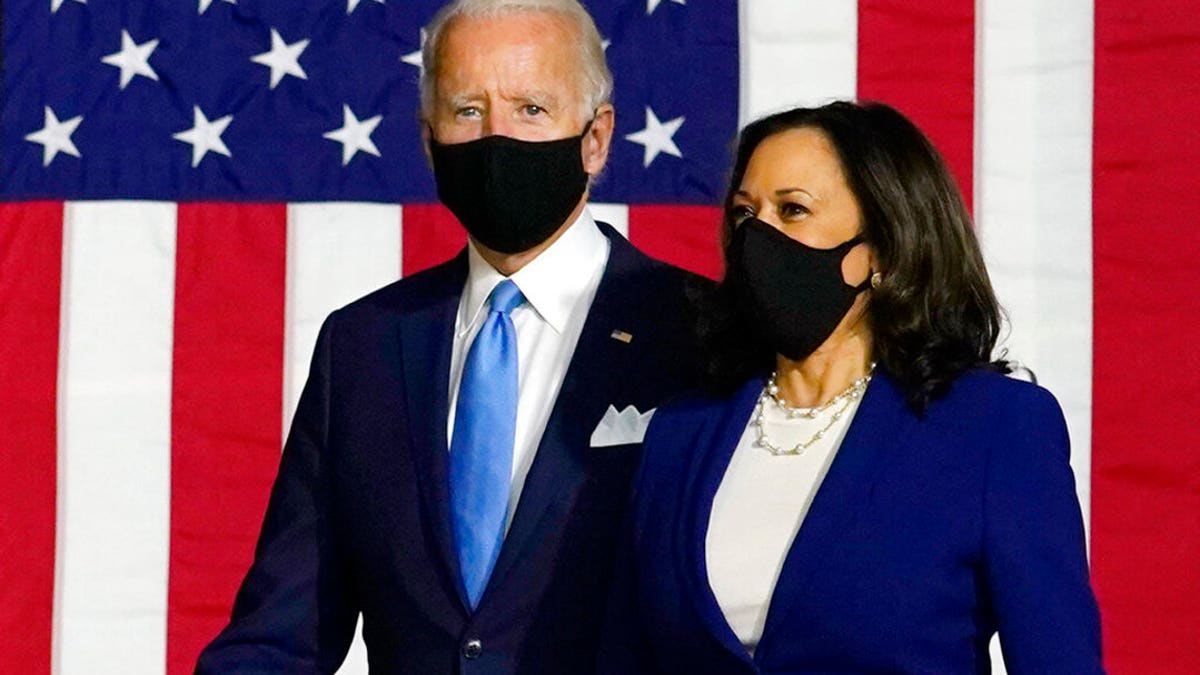 Democratic presidential candidate former Vice President Joe Biden and his running mate, Sen. Kamala Harris, D-Calif., arrive to speak at a news conference at Alexis Dupont High School in Wilmington, Del., Wednesday, Aug. 12, 2020. Biden and Harris both made comments suggesting Trump may push an unsafe coronavirus vaccine on the American people. (AP Photo/Carolyn Kaster)