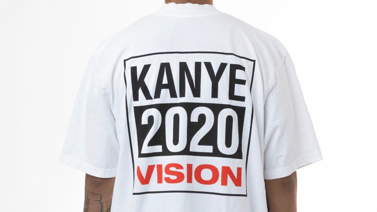A white T-shirt with a block-lettered logo reads "Kanye 2020 vision.”