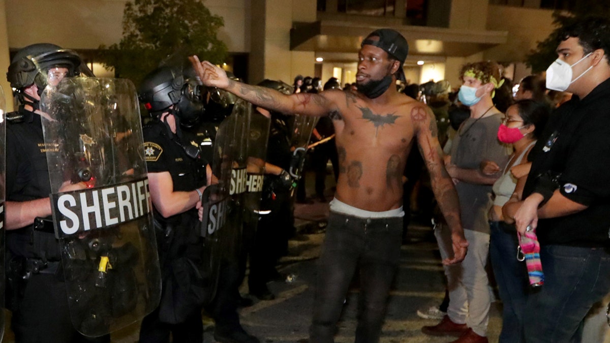 A man confronts police outside the Kenosha Police Department in Kenosha, Wis., during protests following the police shooting of Black man Jacob Blake August 23, 2020. (Mike De Sisti/Milwaukee Journal Sentinel via USA TODAY via REUTERS)