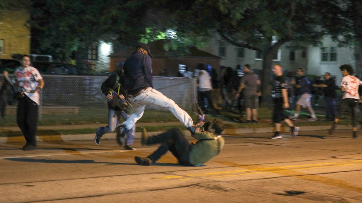 Fights breaking out during the third day of protests over the shooting of Jacob Blake in Kenosha, Wisconsin.