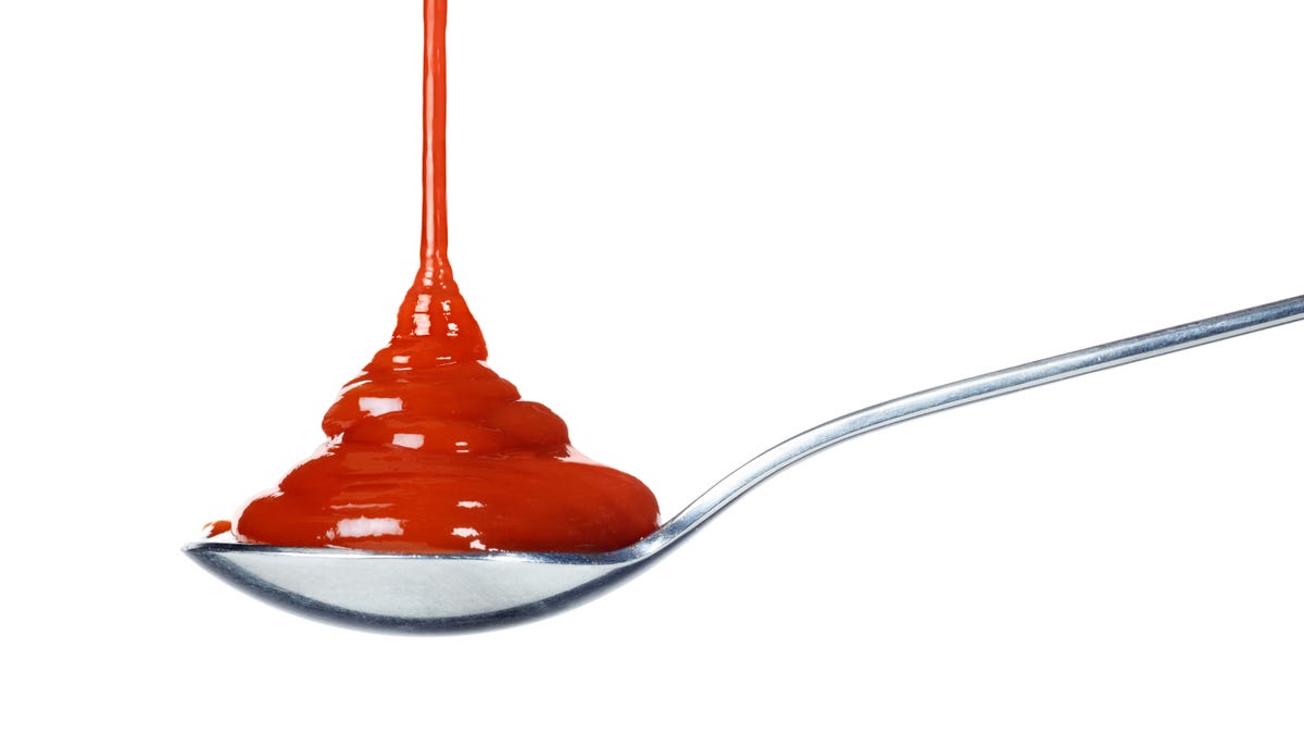 Ketchup pouring on a spoon