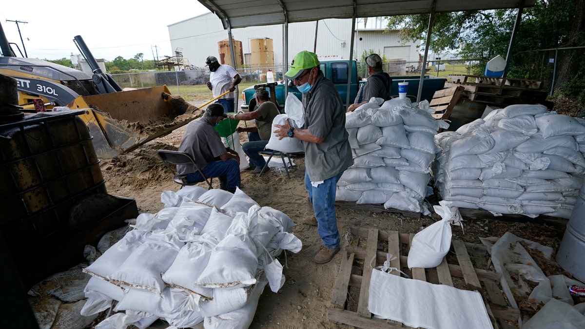 Municipal workers fill sandbags for the elderly and those with disabilities ahead of Hurricane Laura in Crowley, La., Tuesday, Aug. 25, 2020.