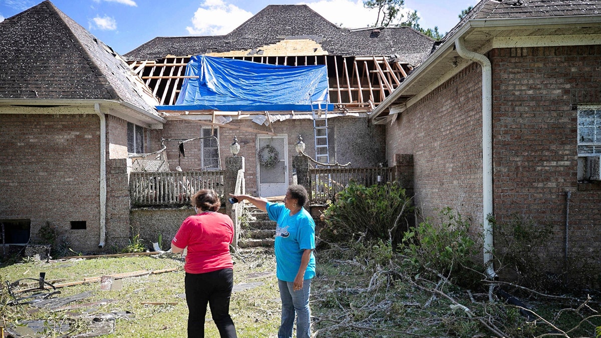 Homeowner Brenda Wilson, right, shows Cally Edwards of the American Red Cross the damage to the rear of her home on Woodard Road in rural Bertie County on Tuesday, August 4, 2020 near Windsor, N.C.
