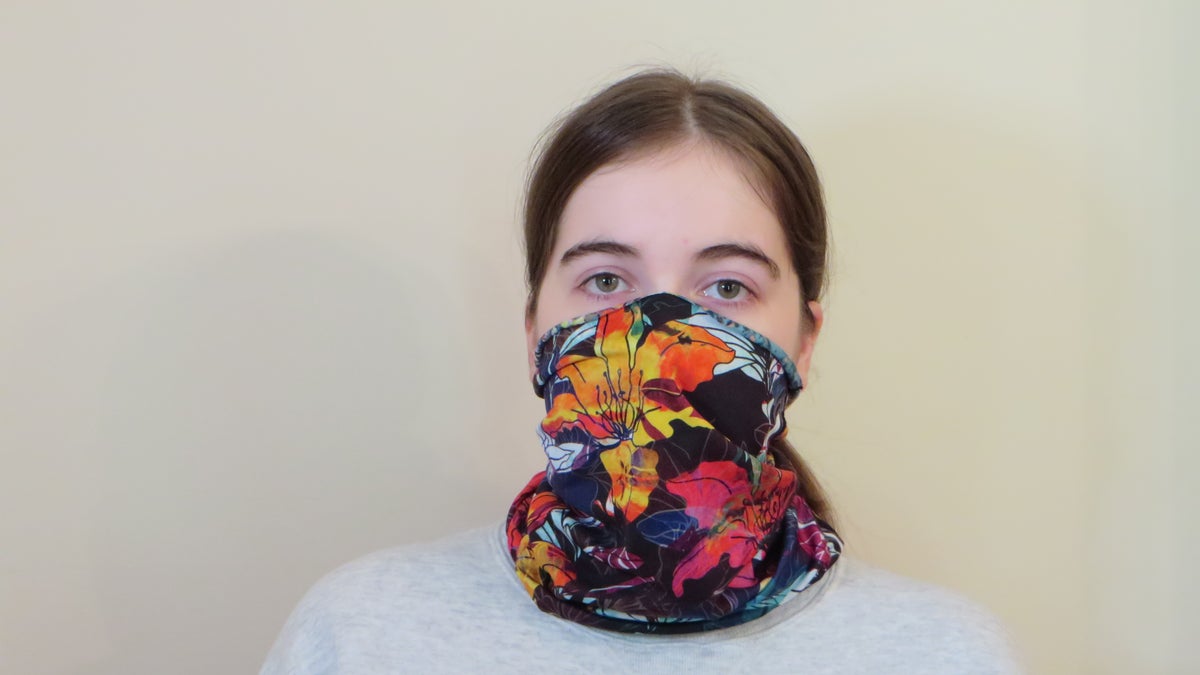 Emma Fischer, study co-author and student at Duke University, dons a neck gaiter. Study co-author Warren S. Warren says this neck gaiter is slightly stretchy and opaque when worn, but single layer and thin enough to see a light through it. (Photo Credit: Martin Fischer, Duke University)