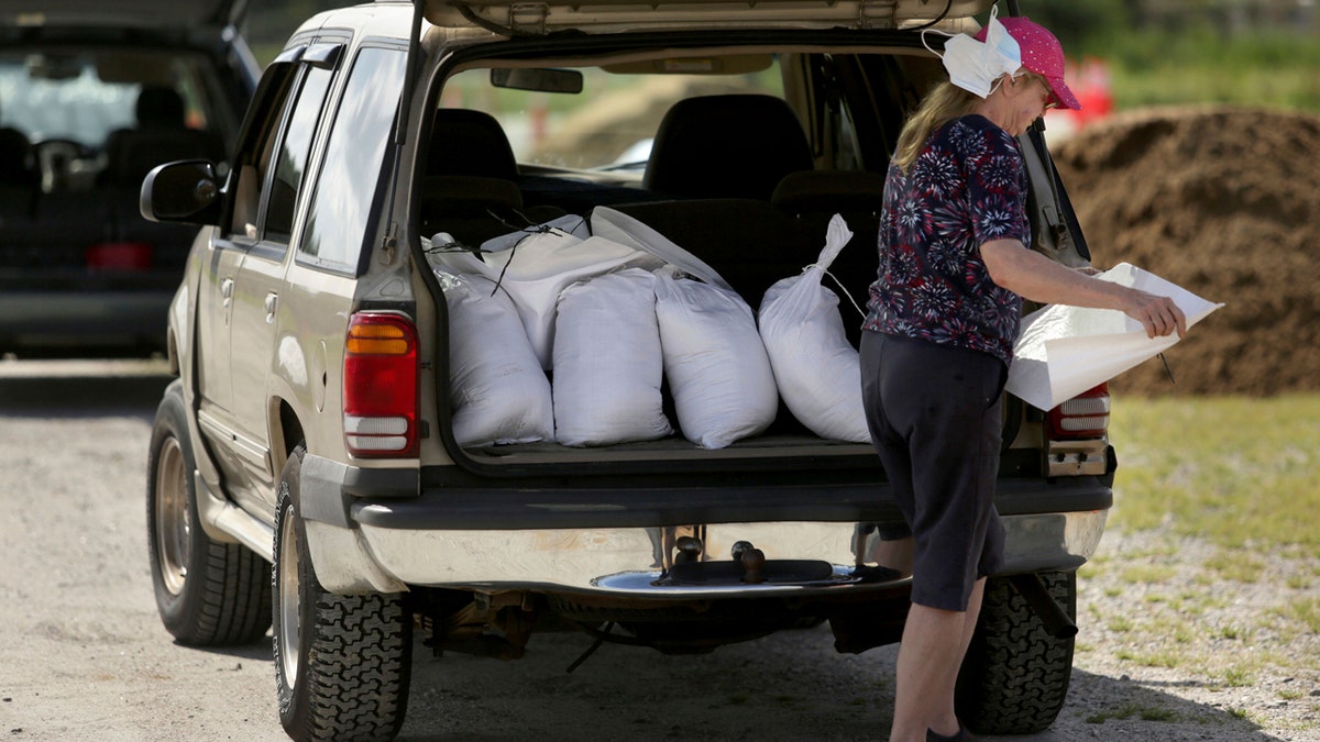 Joyce Weaver, and others fill their vehicles with sandbags in preparation for Tropical Storm Isaias Monday, August 3, 2020 at the Virginia Beach Sportsplex, Va.