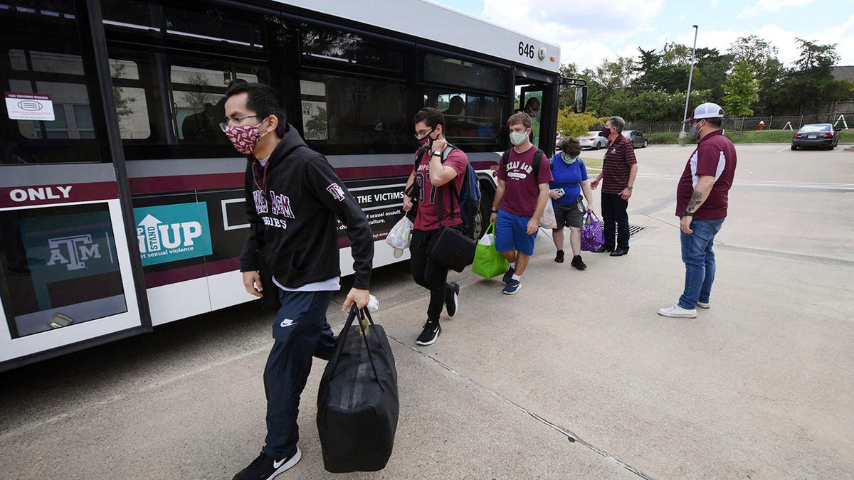 Evacuated students from Texas A&amp;M University at Galveston arrive by bus at Aloft College Station on Tuesday in College Station, Texas. (College Station Eagle via AP)