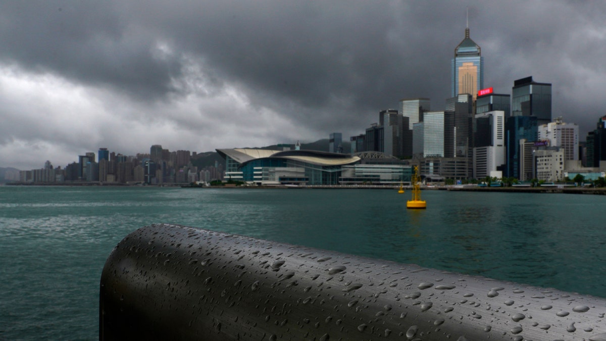 Rain droplets line a railing along the waterfront of Victoria Harbour in Hong Kong Wednesday, Aug. 19, 2020.