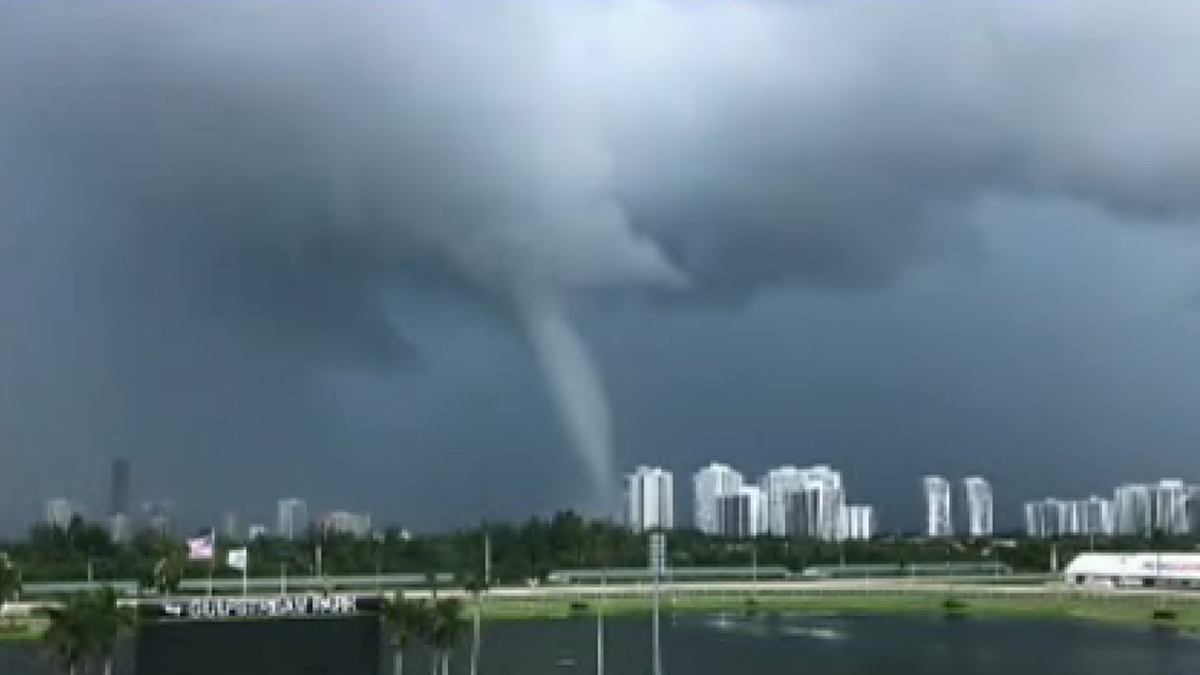 A waterspout briefly hugged the coast in Southern Florida Wednesday afternoon, awing residents who could see it from miles around the densely populated area, according to local reports and videos shared on social media.