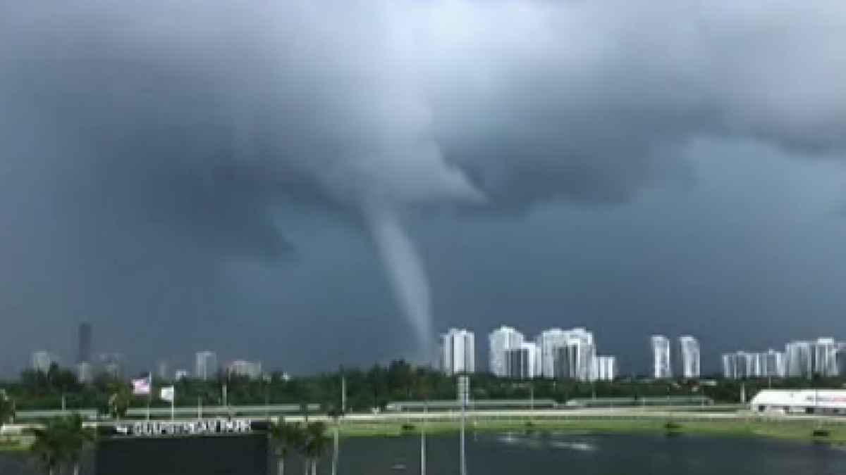 A waterspout briefly hugged the coast in Southern Florida Wednesday afternoon, awing residents who could see it from miles around the densely populated area, according to local reports and videos shared on social media.