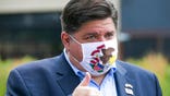 FILE - In this July 16, 2020, file photo, Illinois Gov. J.B. Pritzker meets with people at City Market in Rockford, Ill. Gov. Pritzker set guidelines for youth sports on Wednesday, July 29, 2020, because of incidents where COVID-19 spread at sports camps and even in Major League baseball, and he warned that the growing number of cases in Illinois could result in tougher restrictions on social interaction.(Scott P. Yates/Rockford Register Star via AP, File)