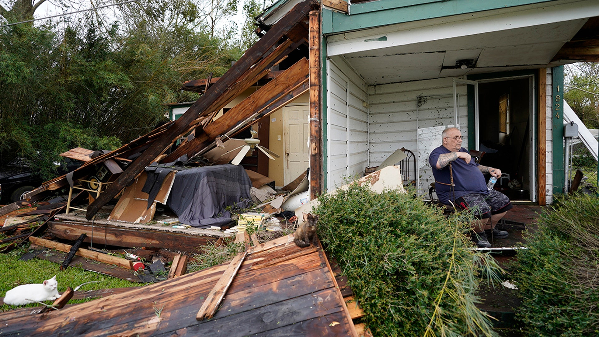 Chris Johnson sits outside his destroyed home after Hurricane Laura moved through Lake Charles, La,, Aug. 27, 2020.
