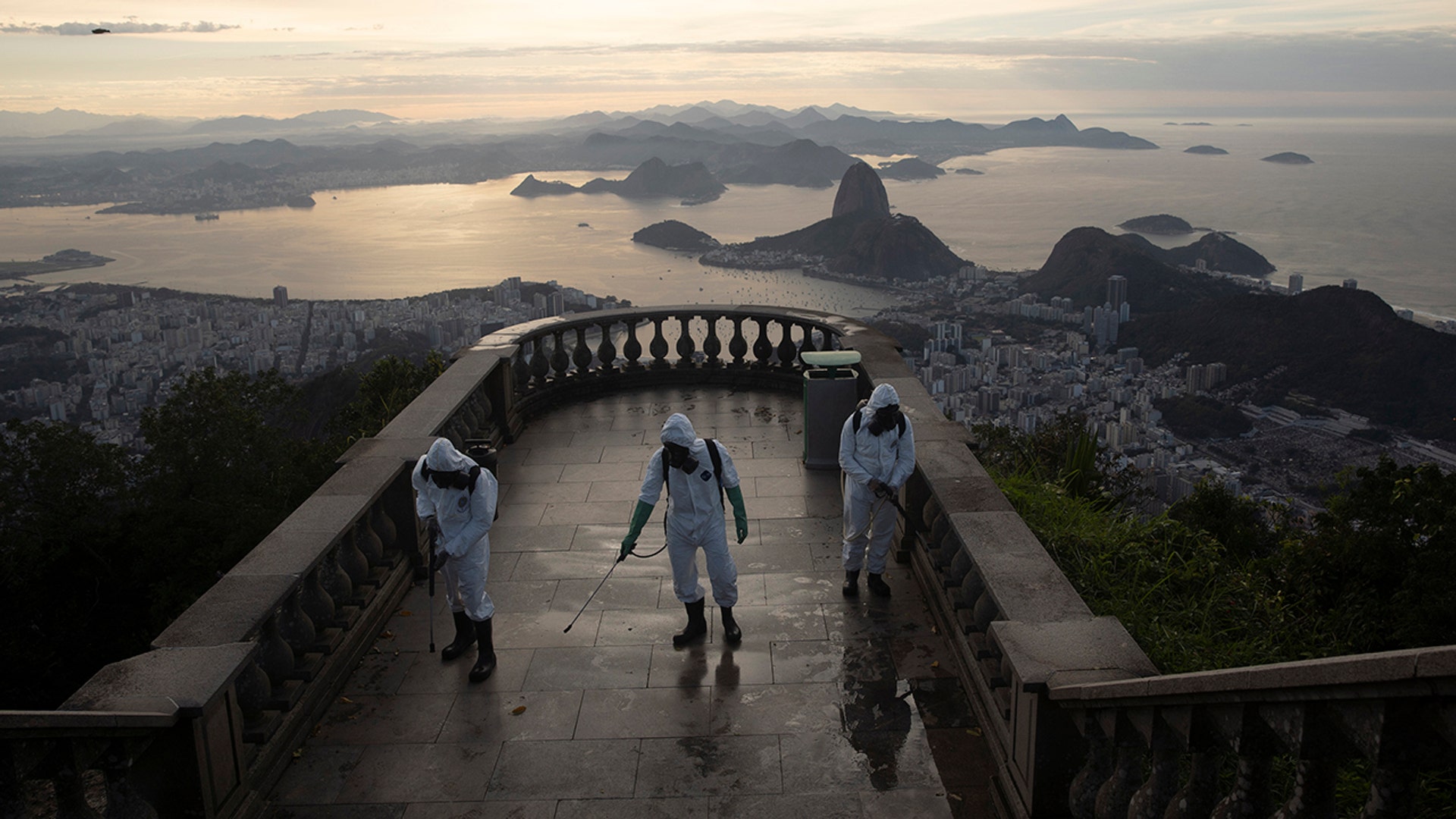 Soldiers disinfect the closed Christ the Redeemer site to prepare for what tourism officials hope will be a surge in visitors in the upcoming weekend as health restrictions are eased amid the new coronavirus pandemic in Rio de Janeiro, Brazil, Aug. 13, 2020.