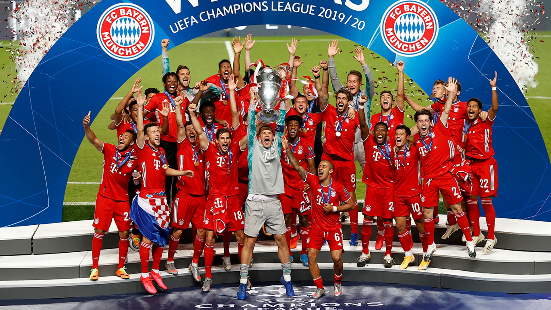 Bayern Munich's goalkeeper Manuel Neuer lifts the trophy after they won the Champions League final soccer match against Paris Saint-Germain in Lisbon, Portugal, Aug. 23, 2020.