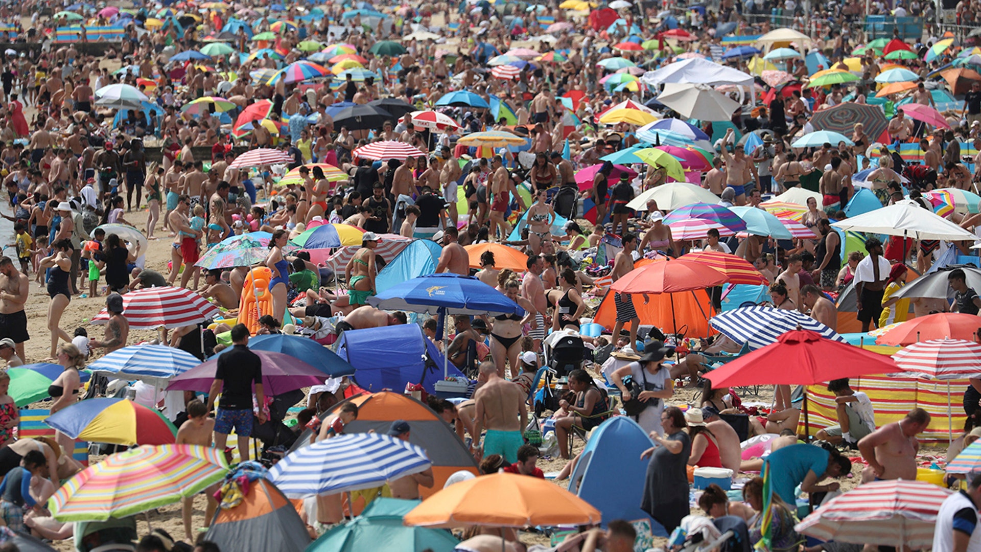 People enjoy the hot weather on the beach in Bournemouth, England, Aug. 8, 2020.