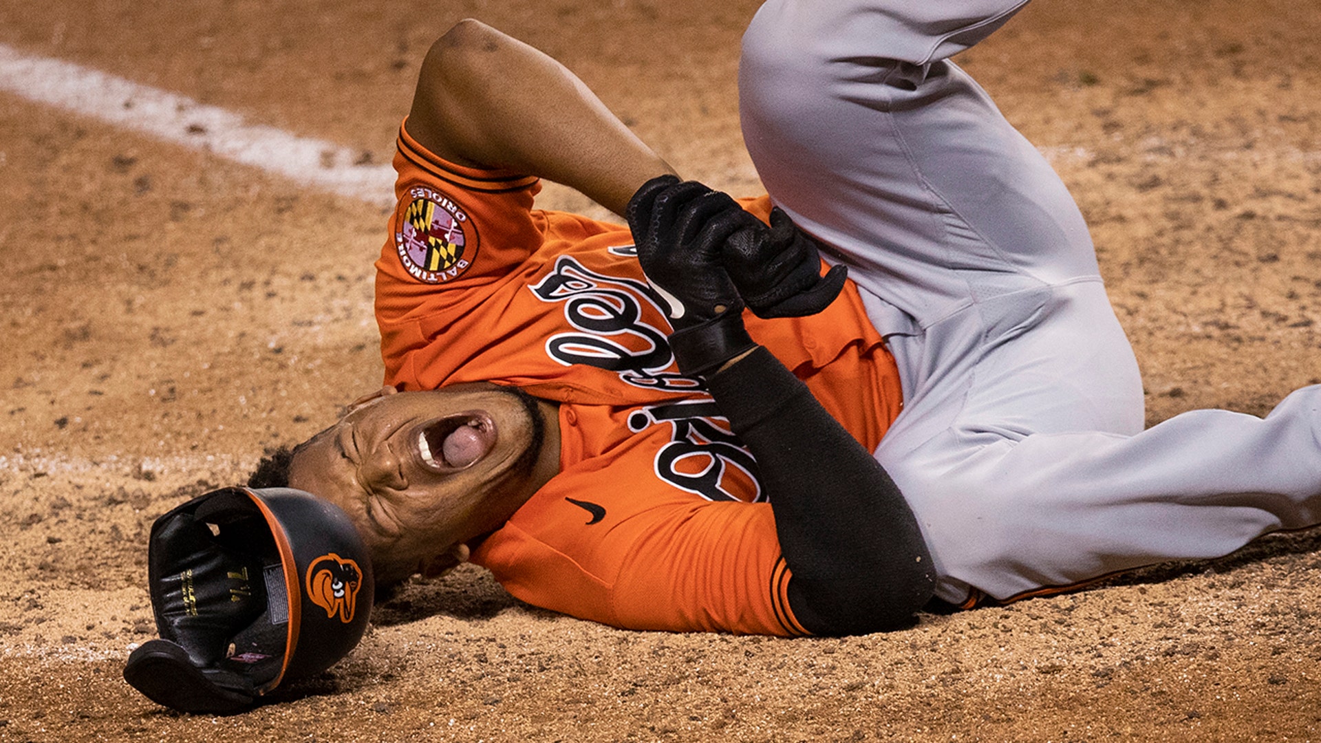 Baltimore Orioles' Pedro Severino grimaces after getting hit by a pitch during the ninth inning of the team's baseball game against the Washington Nationals in Washington, Aug. 8, 2020.