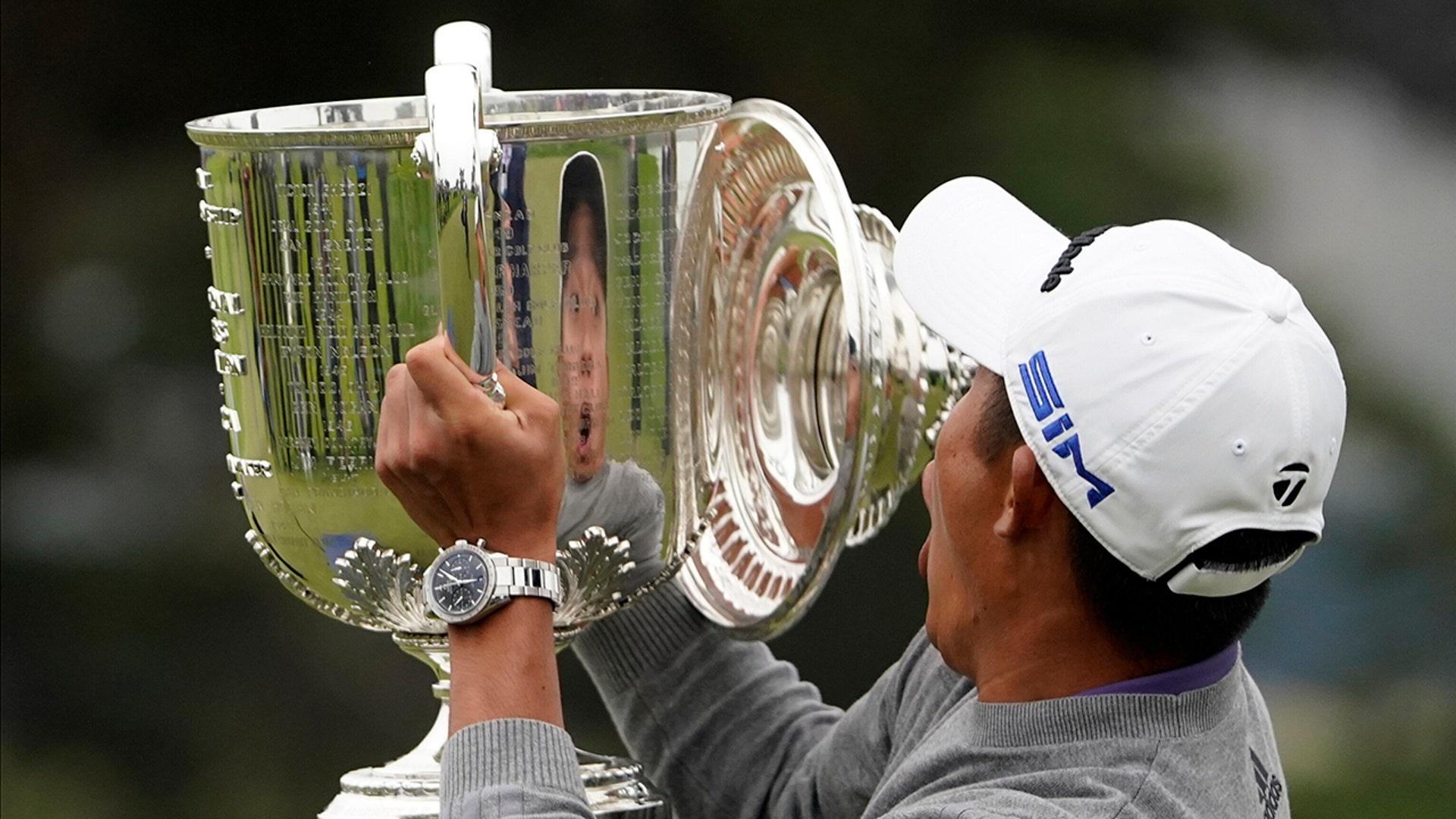 Collin Morikawa reacts as the top of the Wanamaker Trophy falls after winning the PGA Championship golf tournament in San Francisco, Aug. 9, 2020.