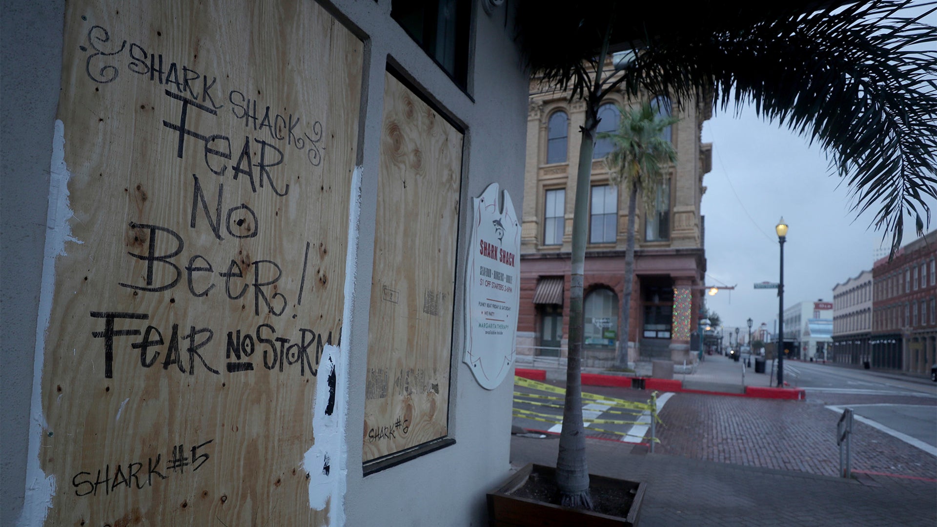 The Shark Shack Beach Bar and Grill is boarded up on the nearly deserted Strand Street in Galveston, Texas, as business owners and residents wait for Hurricane Laura on Aug. 26.