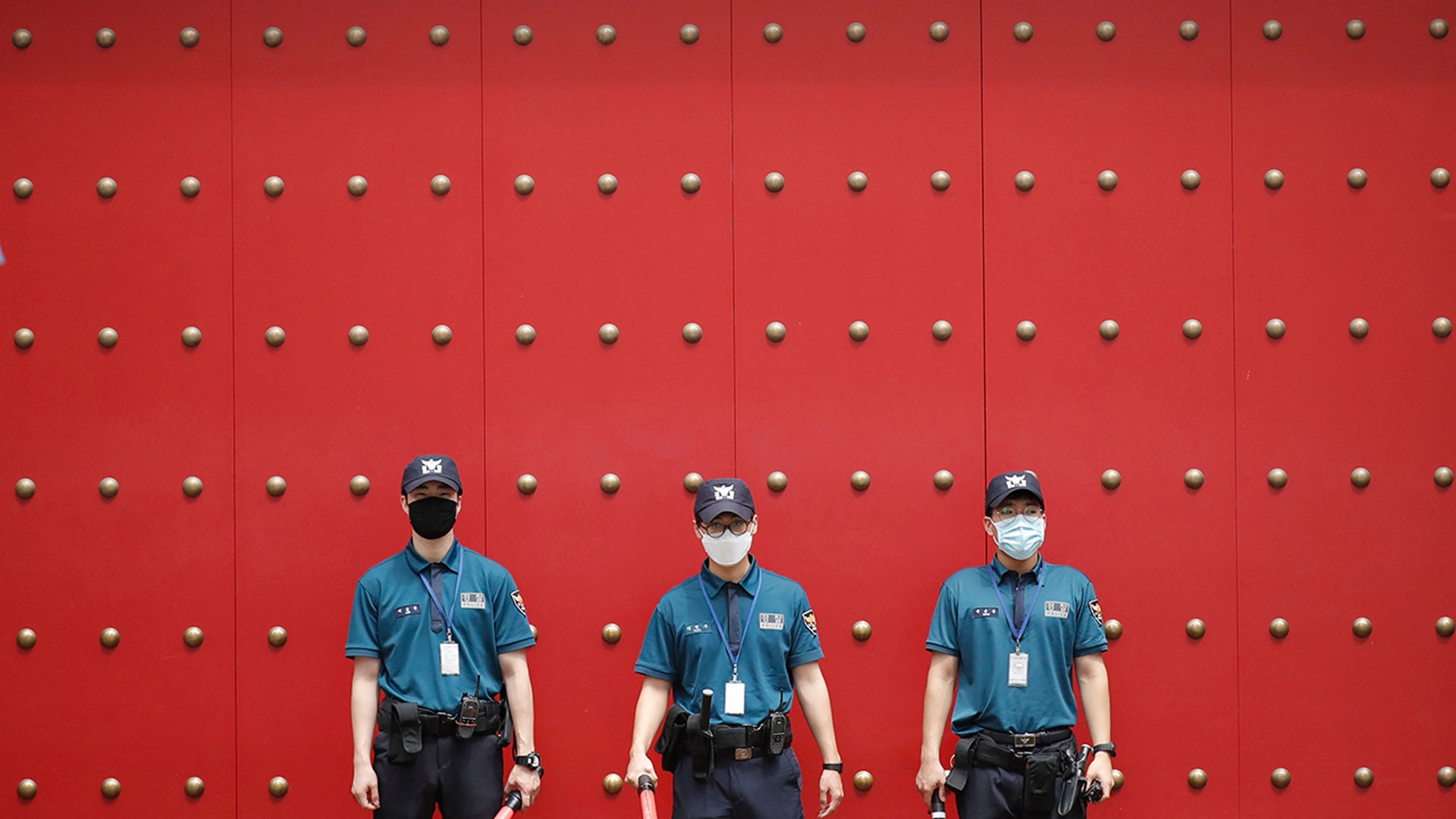 Police officers wearing face masks to help protect against the spread of the coronavirus, stand guard in downtown Seoul, South Korea, Aug. 4, 2020. 