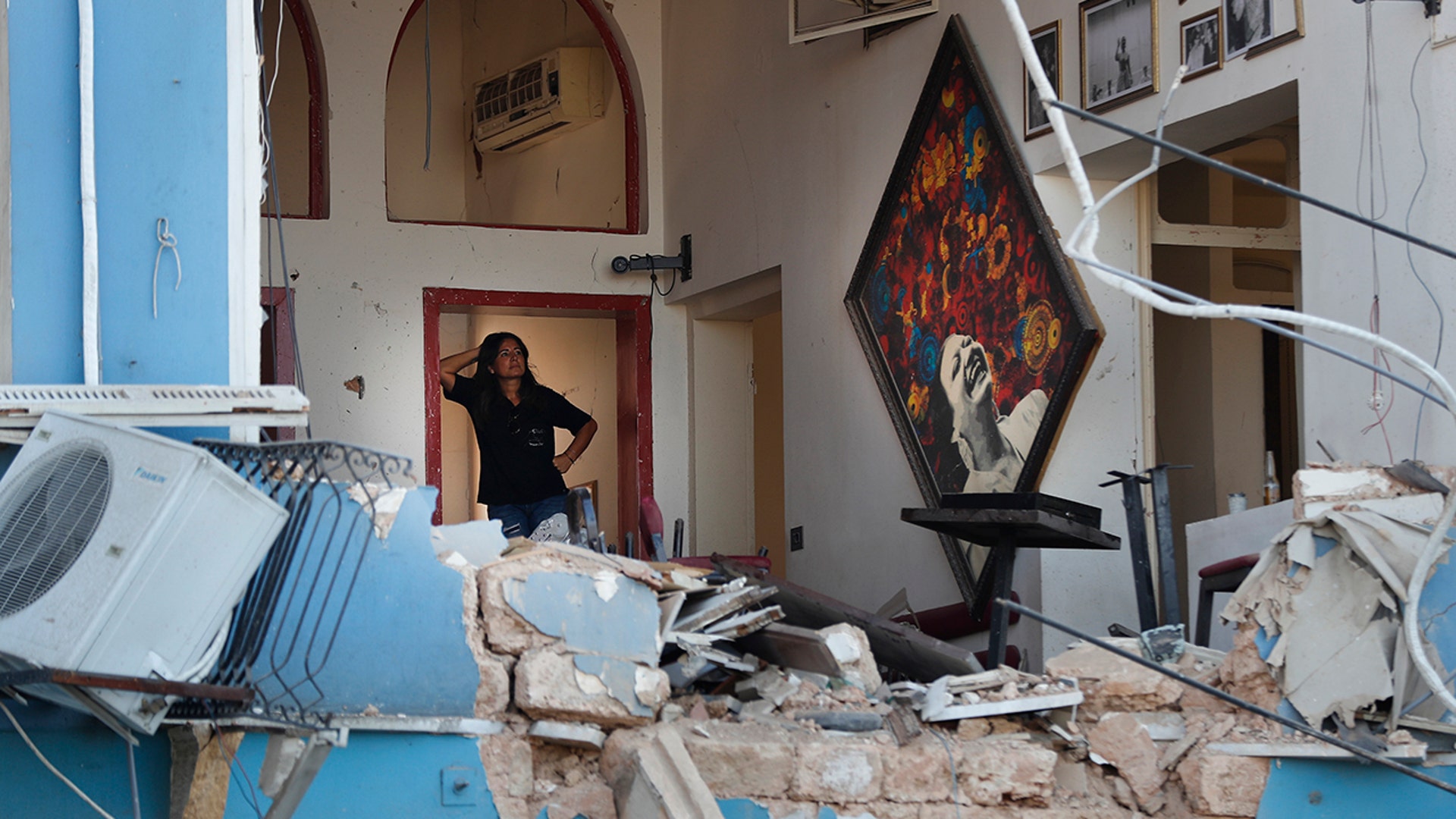 A woman stands inside a damaged restaurant a day after an explosion hit the seaport of Beirut, Lebanon, Aug. 5, 2020. 