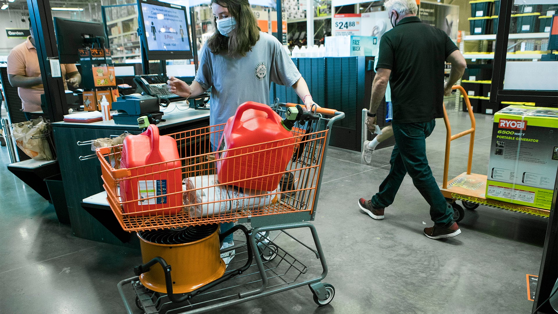 Gigi Hlavink purchases gas cans and other supplies at a Home Depot store while preparing for the possible landfall of Hurricane Laura on Aug. 25, in Houston.