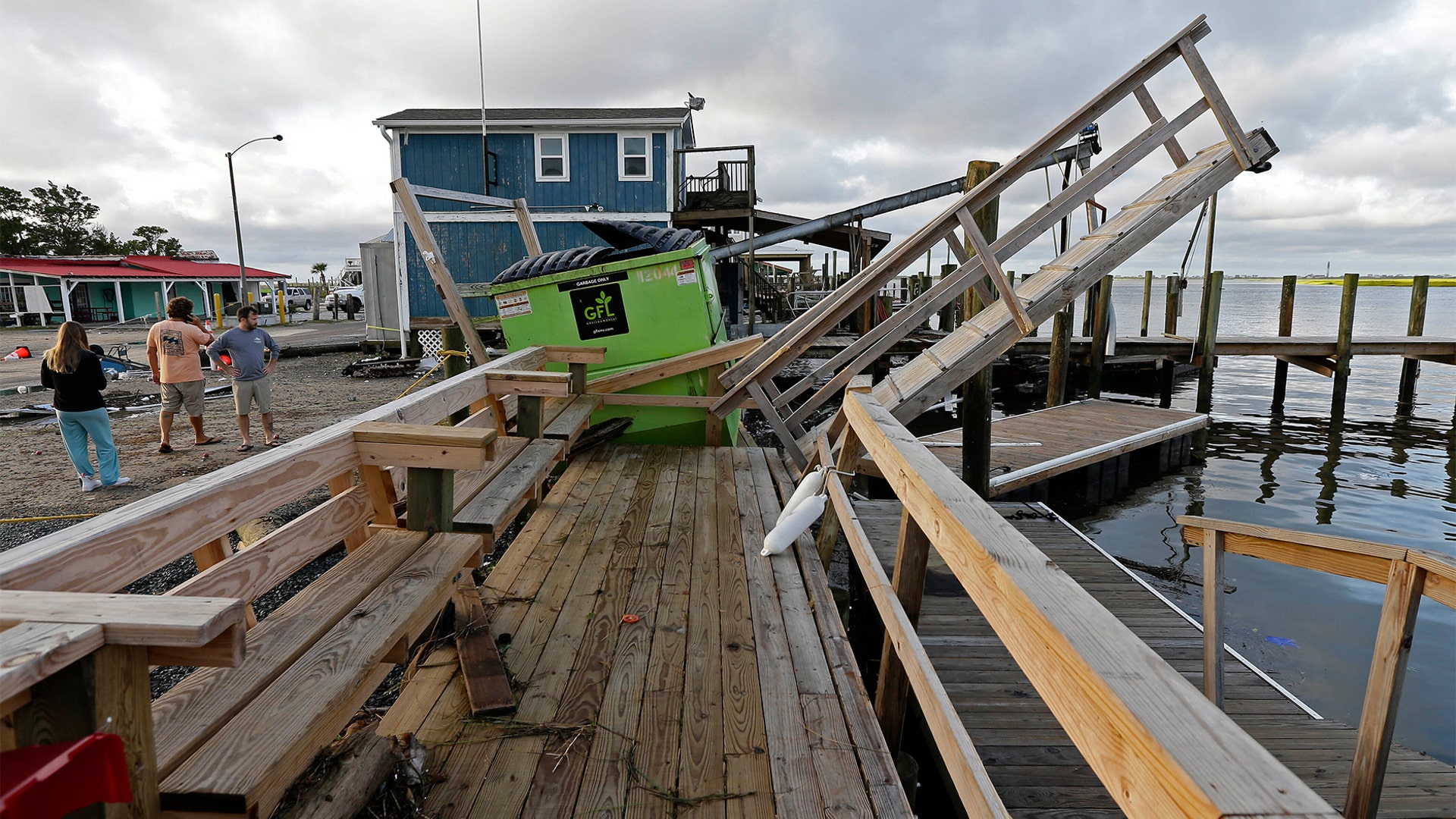A waterfront dock shows damage following the effects of Hurricane Isaias in Southport, N.C., Tuesday, Aug. 4, 2020.