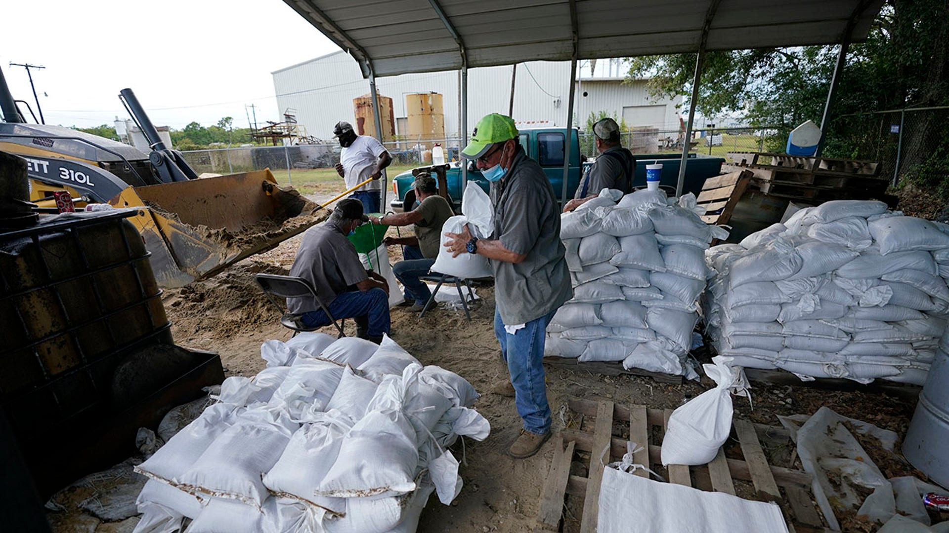Municipal workers fill sandbags for the elderly and those with disabilities ahead of Hurricane Laura in Crowley, La., Tuesday, Aug. 25, 2020. (AP Photo/Gerald Herbert)