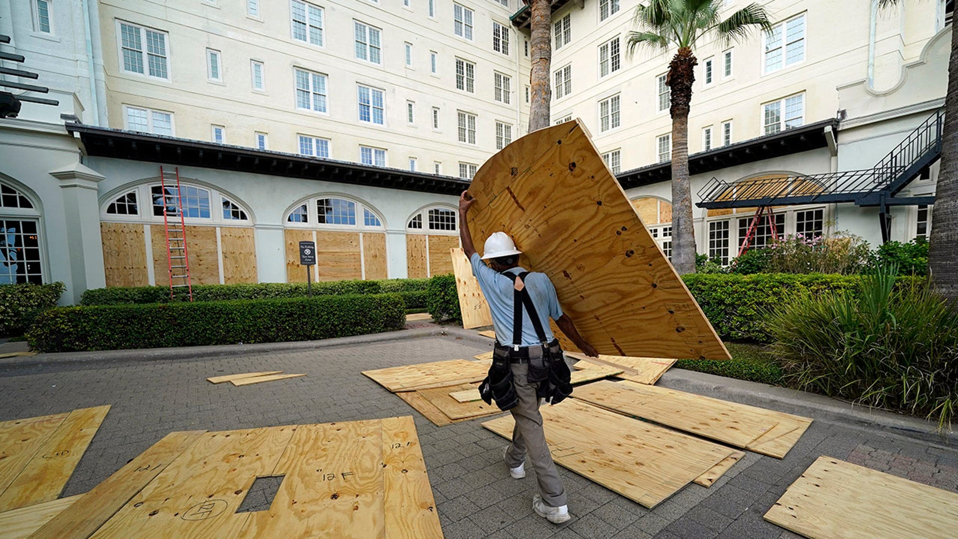 Workers board up windows at the Galvez Hotel &amp; Spa Tuesday, Aug. 25, 2020, in Galveston, Texas, as Hurricane Laura heads toward the Gulf Coast. (AP Photo/David J. Phillip)