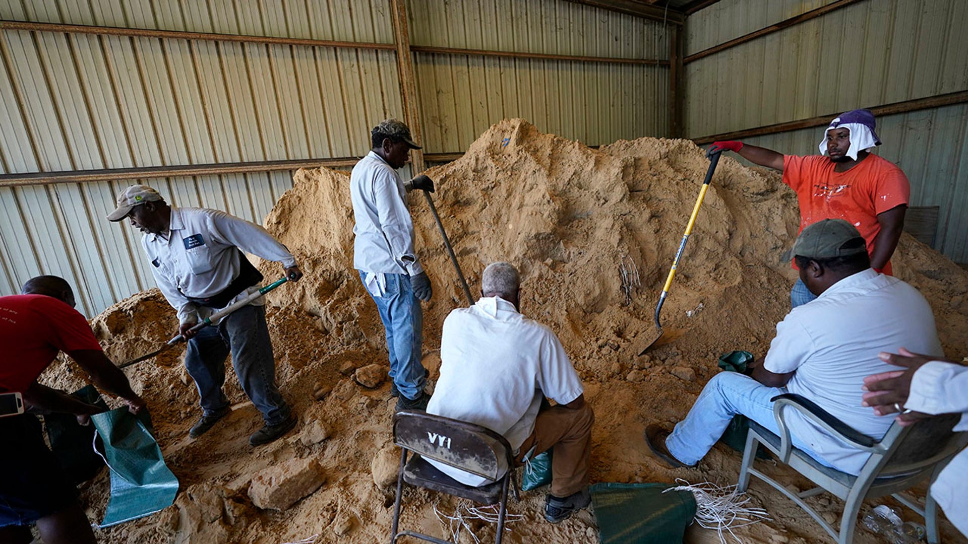 Municipal workers fill sandbags for residents in advance of Hurricane Laura in Abbeville, La., Tuesday, Aug. 25, 2020. (AP Photo/Gerald Herbert)