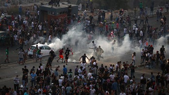 Lebanese protesters storm government buildings as prime minister vows early elections