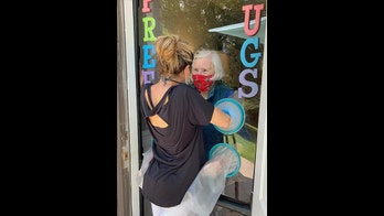 Safe 'hugging booths' allow the elderly to connect with family during coronavirus pandemic