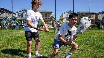 2 teen lacrosse players score goal in fight against hunger