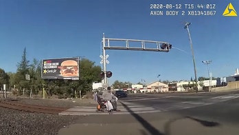 California police officer pulls man in wheelchair from oncoming train with seconds to spare, video shows