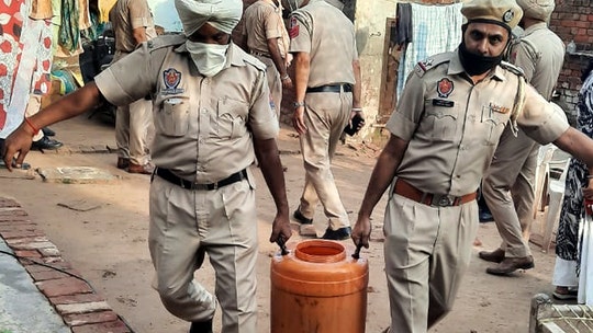 Tainted alcohol in India kills dozens, spurring authorities to conduct over 100 raids