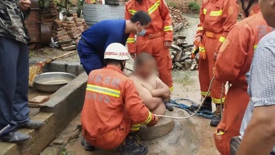 Chinese man's big belly saves him from falling down well