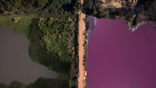 Scientists puzzled after Paraguayan lagoon turns purple on one side, remains blue on other