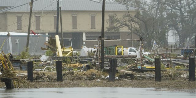 Flooding surrounds damaged homes and buildings Friday, Aug. 28, 2020, in Cameron, La., after Hurricane Laura moved through the area Thursday. (AP Photo/David J. Phillip)