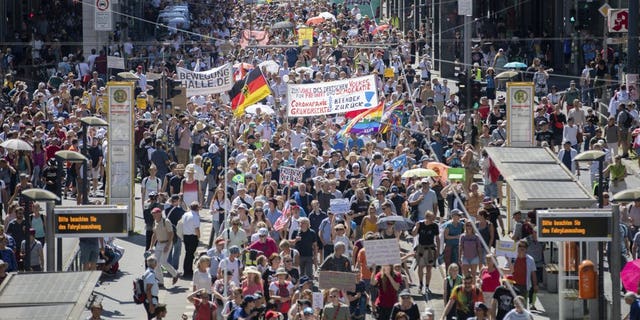 Thousands march along the 'Friedrichstrasse' during the demonstration against corona measures in Berlin, Germany, Saturday, Aug. 1, 2020. The initiative "Querdenken 711" has called for this. The motto of the demonstration is "The end of the pandemic - Freedom Day".