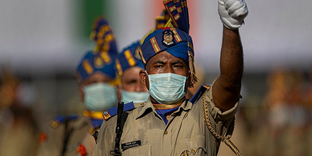 Indian paramilitary soldiers wearing face masks participate in the final dress rehearsals for India's Independence Day celebrations in Gauhati, India, Thursday, Aug. 13, 2020. (AP Photo/Anupam Nath)
