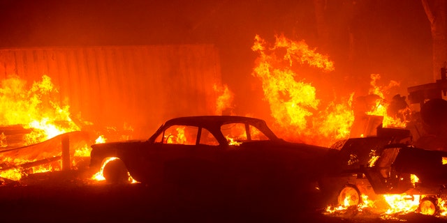 A vehicle burns in the Lake Hughes fire in Angeles National Forest on Wednesday, Aug. 12, 2020, north of Santa Clarita, Calif.