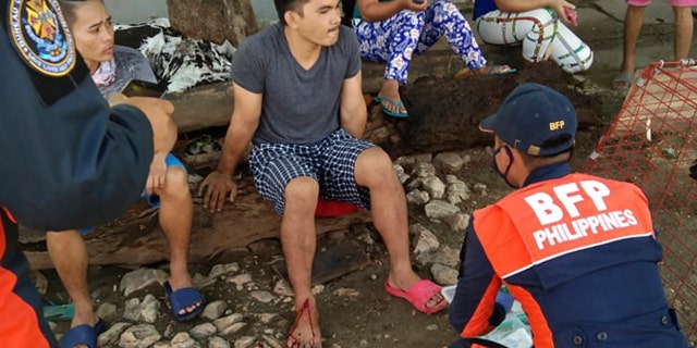 An injured man is treated after a strong earthquake struck in Cataingan, Masbate province, central Philippines on Tuesday Aug. 18, 2020.