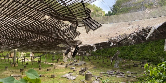 This photo provided by the Arecibo Observatory, shows the damage done by a broken cable that supported a metal platform, creating a 100-foot gash to the radio telescope's reflector dish in Arecibo, Puerto Rico, Tuesday, Aug. 11, 2020.