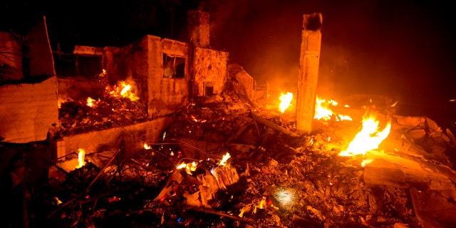 The Lake Hughes fire burns a home in Angeles National Forest on Thursday, Aug. 13, 2020, north of Santa Clarita, Calif.