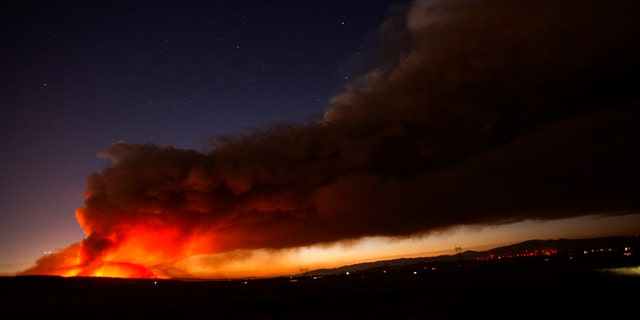 The Lake Hughes fire sends a plume of smoke over Angeles National Forest on Wednesday, Aug. 12, 2020, north of Santa Clarita, Calif.